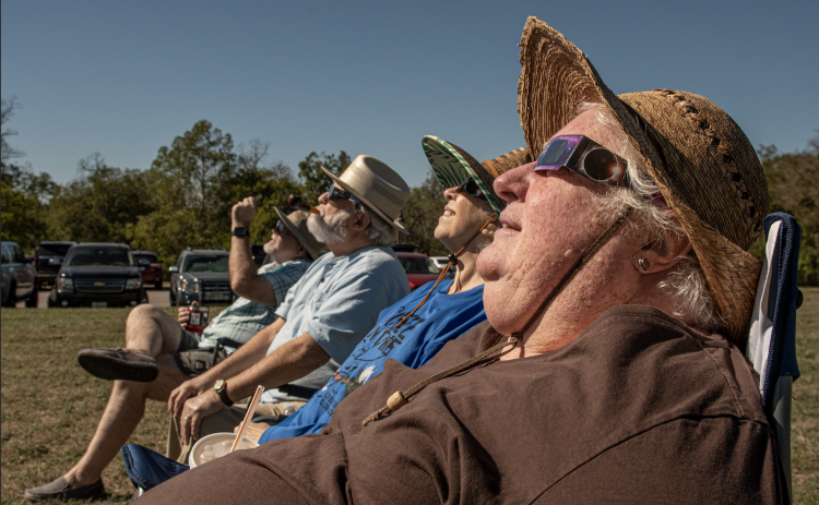 Keri Davis, Vicki Goodrich, Robert Goodrich and Duane Davis watch the annular eclipse during a October 14, 2023, gathering at Berry Springs Parks & Preserve. (Sun Archive)