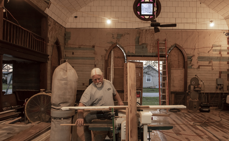 Robert Halstrom works in what was once the sanctuary  at the former Granger First United Methodist Church  on Monday, March 11, 2024.  Halstrom and his wife JoAnne, a Wimberley couple,  purchased the early-1900s church in late-2019.   Robert has been working on the church since then, with plans to eventually transform it into an event venue.  Photo by Andy Sharp. 