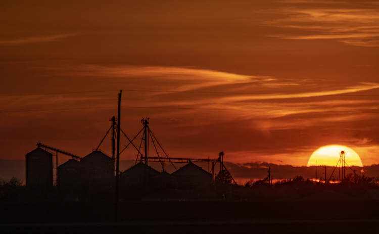 The sun begins to go down over grain elevators in downtown Granger just before 7:30p.m. on Monday, March 11.  Photo by Andy Sharp