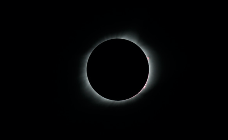 Solar flares peek out from behind the moon during 2017’s total solar eclipse, the most recent in the continental U.S. (Courtesy Jeff Ridings)