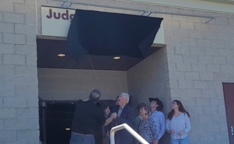 Former County Judge Dan A. Gattis, center, unveils the naming plaque to the Judge Dan A. Gattis Pavilion located at the county Expo Center, April 11. Photo by Nalani Nuylan.