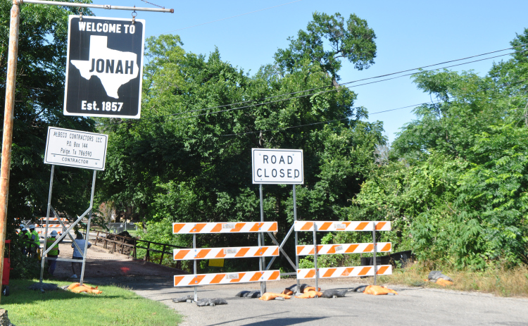 Contractors stand on the Jonah Bridge Tuesday, May 14, as machinery underneath prepares the area for demolition. The about 100-year-old bridge was part of Old Highway 29 and took vehicles over a creek. Photo by Nick Cicale.