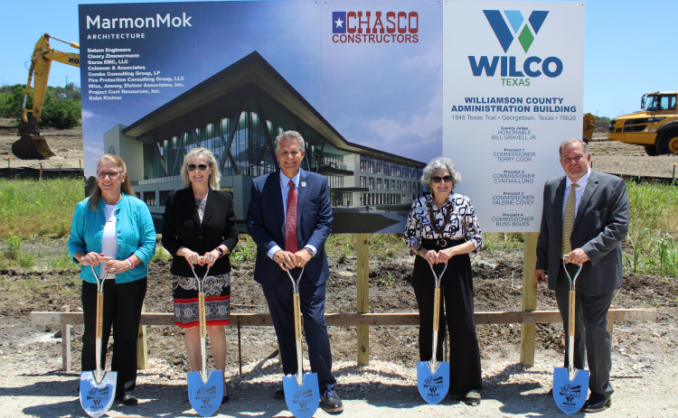 County Commissioners Cynthia Long, Valerie Covey, County Judge Bill Gravell, Terry Cook and Russ Boles pose at the site of the new county headquarters.