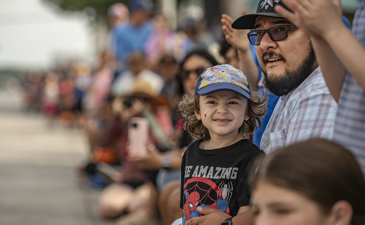 2-year-old Elliott Araiza, with his dad Bert Araiza, enjoyed watching the parade along Austin Avenue during the 25th Annual Red Poppy Festival on Saturday, April 27, 2024.    Photo by Andy Sharp.