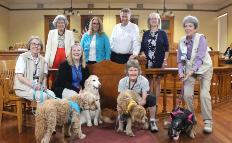 Williamson County commissioners stand with therapy dogs Bubby, Sage, Molly and Magnolia, with their owners for National Therapy Animals Day at the county courthouse April 30. Photo courtesy of Williamson County.