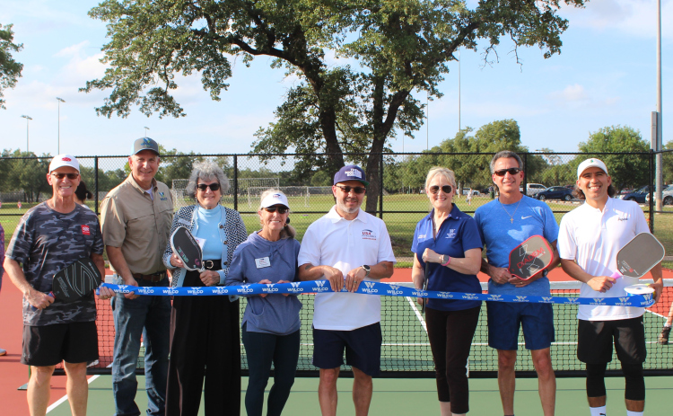 Representatives celebrate the opening of new pickleball courts at Southwest Williamson County Regional Park in Leander.  Cutting the ribbon are, from left, Steve Loranger from USA Pickleball, Williamson County Parks Director Russell Fishbeck, Commissioner Terry Cook, Jo Tramell from USA Pickleball, George Olivencia from USA Pickleball, Commissioner Valerie Covey, Walter Sotillo from Round Rock Pickleball and Izaak Gonzalez from HUDEF Pickleball Pro Team. Photo courtesy of Williamson County.