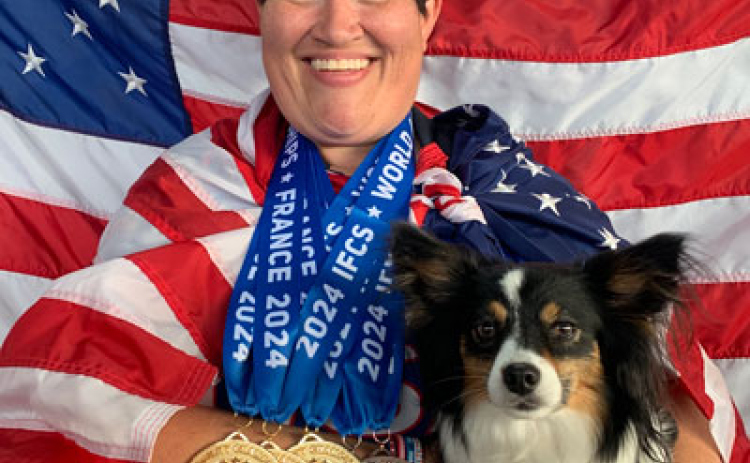 Courtney Moore of Leander poses with her Border Collie/Papillon mix “Butter” after winning five medals at the 2024 World Agility Championship in France in May. Photo courtesy of The United States Dog Agility Association.