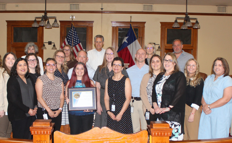 County Commissioners and Wilco’s Human Resources Department pose with Mental Health America’s 2024 Gold Bell Seal for Workplace Mental Health award during the June 18 Commissioners Court meeting.  Photo courtesy of Williamson County.