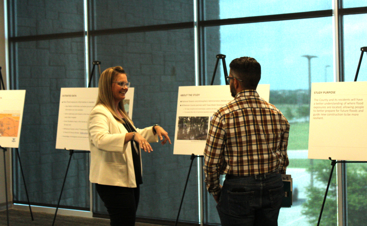 Cindy Engelhardt, left, explains how the Atlas 14 maps show rainfall data to Jarrell City Engineer Jorge L. Hernandez. Photos by Nalani Nuylan.