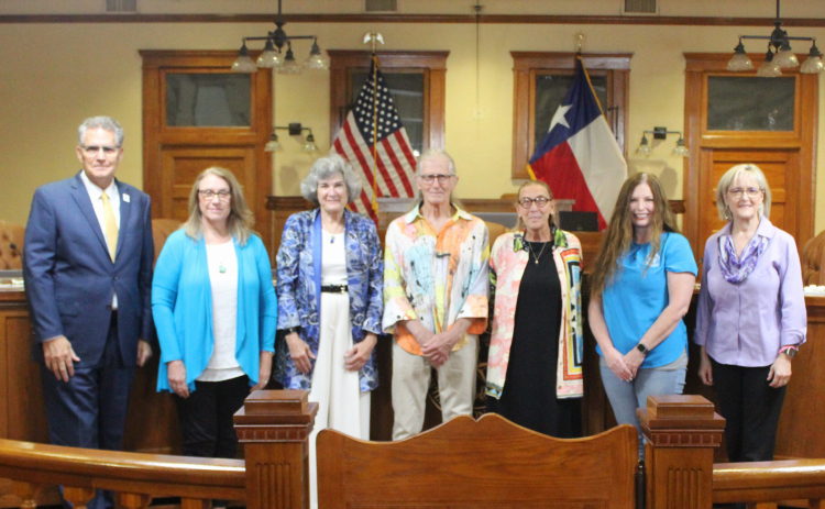 Former City of Florence Mayor Mary Condon, center left, stands with her family and the Williamson County Commissioners at the June 25 meeting at the historic courthouse. Photo courtesy of Williamson County.