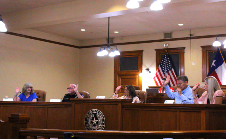 The Williamson County Election Board votes to use pre-printed ballots for the upcoming November election. From left to right: Democratic Party Chair Kim Gilby, County Sheriff Mike Gleason, Wilco Election Administrator Bridgette Escobedo, County Judge Bill Gravell and Republican Party Chair Michelle Evans. Photo by Nalani Nuylan.