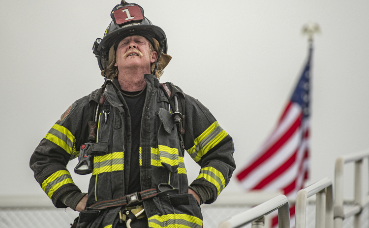 Georgetown Fire Department firefighter Russell Paxton can't hide his weariness near the completion of his participation in the Memorial Stair Climb at Birkelbach Field on Wednesday, September 11, 2024, the 23rd anniversary of the attacks on United States soil in New York, Pennsylvania and Washington, D.C. The Memorial Stair Climb began here in 2011.  Photo by Andy Sharp.