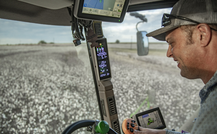 Aaron Martinka navigates his combine through a field of cotton along F.M. 972 east of Walburg  on Tuesday, September 10, 2024. Martinka is harvesting 1,100 acres of cotton this year.  Photo by Andy Sharp.