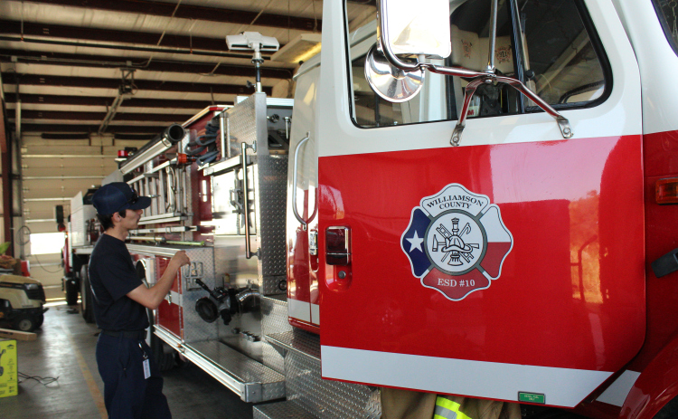 Firefighter Stephen Barnes gives a tour of one of the firetrucks at the ESD 10 station in  Coupland. Photo by Nalani Nuylan.