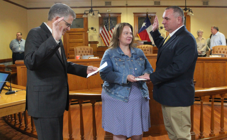 Ron Cunningham, right, gets sworn in as the Interim Fire Marshal for Williamson County during a meeting October 29. He was joined by his wife, pictured center.  Photo courtesy of Williamson County.