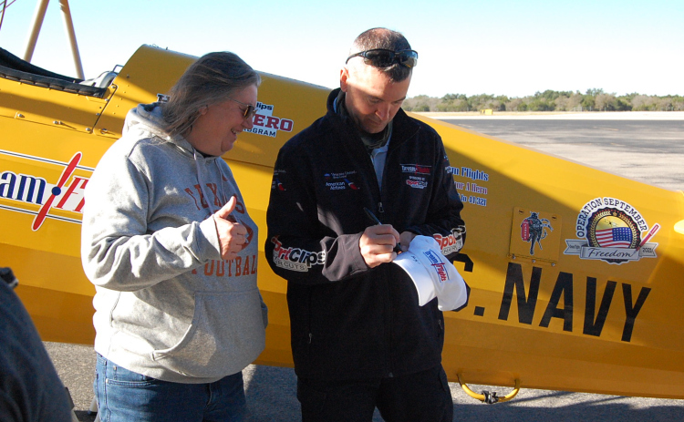 After her flight, Army veteran Emily Johnson waits for a Dream Flights hat signed by pilot Hunter Stuckey. (Photo by Kaitlyn Wilkes)