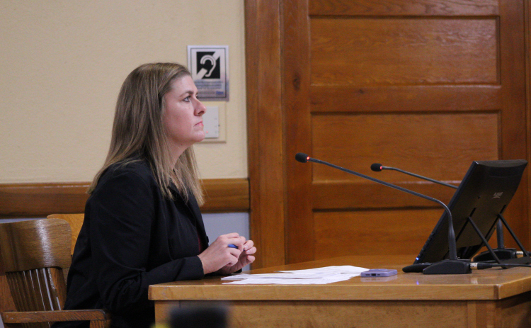 County Manager Rebecca Clemons answers questions about the proposed Death Investigator salaries during the December 10 Commissioners Court meeting. Photo by Nalani Nuylan.