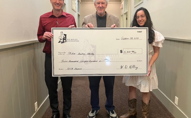 Carl Illig, Kevin Taylor and Gabriela Bravo stand with a check supporting the Wilco Guitar Society. (Photo courtesy Wilco Guitar Society)