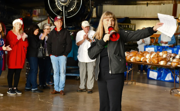 Holiday Meals Delivered organizer Beth Jenkins, front, directs volunteers to deliver holiday meals in the Georgetown airport. Photo Courtesy of Holiday Meals Delivered.