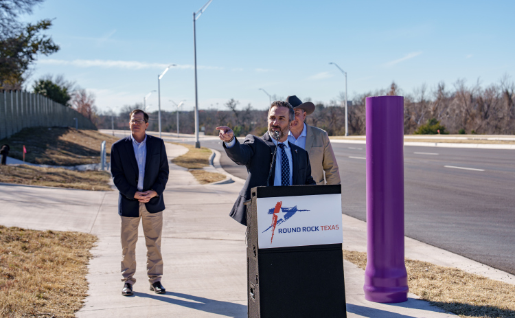 Round Rock Mayor Craig Morgan, front, gives a speech about Kenney Fort Boulevard with Public Works Director Michael Thane, left, and County Commissioner Russ Boles behind. Photo courtesy of the City of Round Rock.