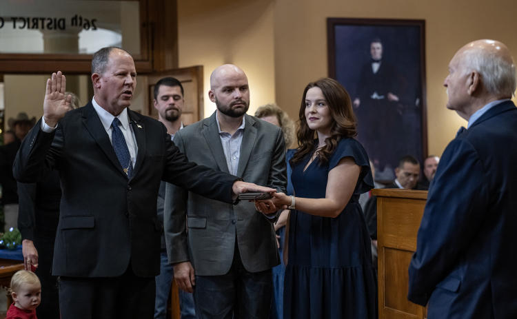 Matthew Lindemann, left, with his son Clark Lindemann, center, and daughter Claire Kolle, right, is sworn in as Williamson County Sheriff by Senior District Judge Billy Ray Stubblefield, right, during induction ceremonies for newly-elected Williamson County officeholders on Wednesday, January 1, 2025.