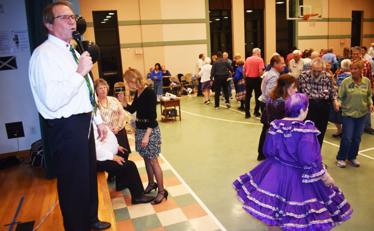 Honored caller Brad Caldwell leads Shirts ‘n’ Skirts dancers after his induction into the Texas State Callers Association Hall of Fame.