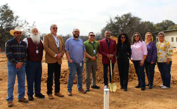 Dr. Satish Chundru, in red, breaks ground with the Williamson County Justices of the Peaces KT Musselman of Precinct 1, center left, and Rhonda Redden of Precinct 4, center right. They are joined by the newly-hired death investigators. Photo by Nalani Nuylan.