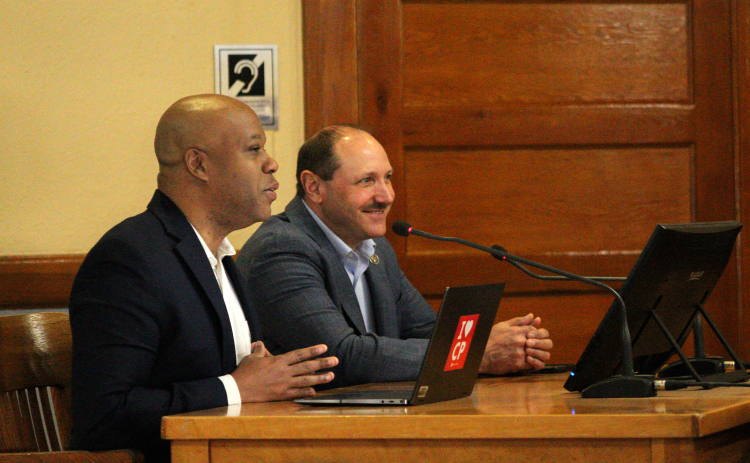 Chief Economic Development Officer for the City of Cedar Park Arthur Jackson, front, and Chief Operating Officer of Firefly Aerospace Dan Fermon, back, explain the economic impact of a spaceport during the meeting. Photo by Nalani Nuylan.