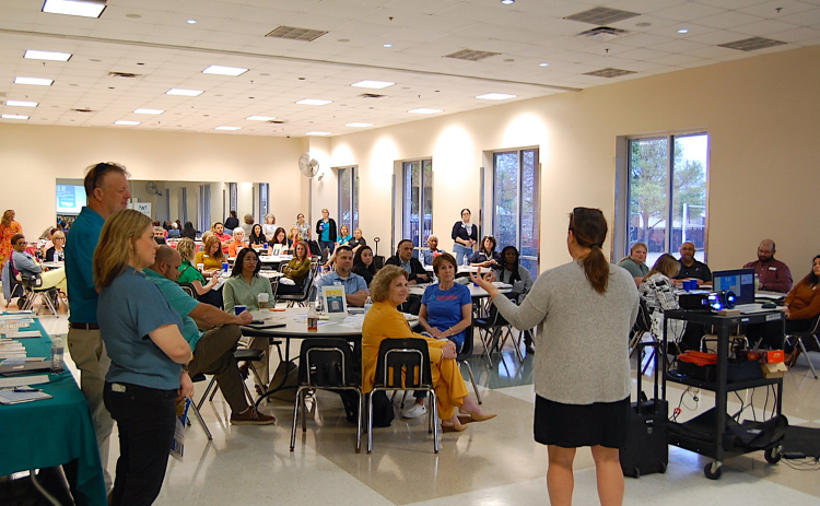 Cat Phelps, right, representing Georgetown’s Rotary Club, speaks to attendees about the need for additional nonprofits partners to contribute toward the September 11 Day of Service. (Photo by Kaitlyn Wilkes)