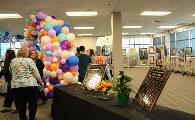 Attendees gather at the entrance of the National Crime Victims’ Rights Week Art Exhibit displayed at the Georgetown Annex, 100 Wilco Way, on April 9. Photo by Nalani Nuylan.