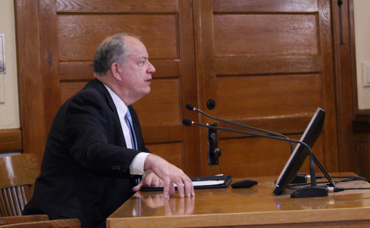 Senior Director of Infrastructure Bob Dale explains the resolution to ask the Central Texas Regional Mobile Authority to conduct a study on Ronald Reagan Boulevard in Williamson County during the April 15 commissioners court meeting. Photo by Nalani Nuylan.