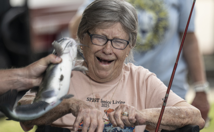 Sybil Naizer, 91, reacts to one of the fish she caught during the 22nd Annual Fishing Tournament held at Taylor’s SPJST Senior Living  on Thursday, April 24.