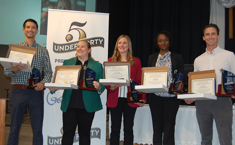 Five Under 40 award recipients, from left, Sam Gallardo, Tori Clark, Kim McAuliffe, Marian Diop and Michael Pickel hold their Congressional Certificates and award from the Rotary Club and Chamber of Commerce. (Photo by Kaitlyn Wilkes)