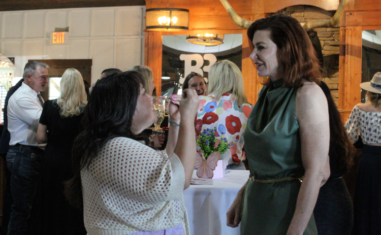 Yesterday’s Gone Life Coach Yoko Ochoa, left, expresses her excitement about the nonprofit’s first fundraiser to founder and executive director Loree Tamayo, May 3.