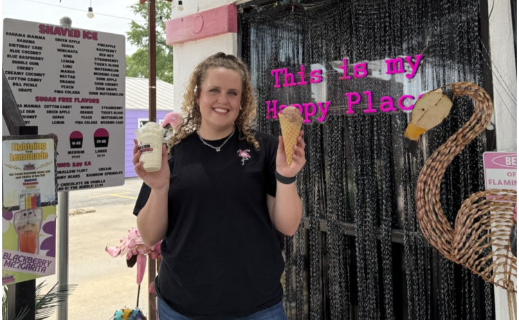 Faith Thomas, the owner of Frozen Flamingo, holding frozen treats. Photo by Abbey Archer