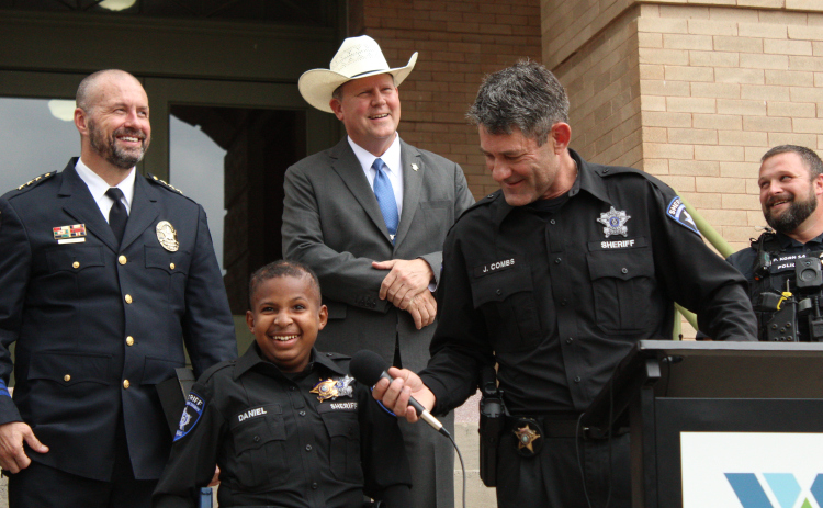 DJ Daniel, joined by Georgetown Police Chief Cory Tchida, far left, Williamson County Sheriff Matt Lindemann, center left, Sheriff Deputy Jeff Combs, center right, and Interim Jarrell Police Chief Pacer Korn on the north side of the courthouse, Monday afternoon.