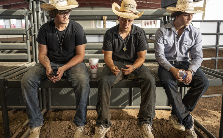 Cameron Blodgett, 17, left, entered in steer wrestling (called chute dogging here), Bryden Gonzales, center, 18, entered in bull riding, and Talan Espinoza, 18, also entered in bull riding, wait for their time in the competition arena during the Bill Pickett Youth Rodeo, held at the Williamson County Expo Center  on Saturday, June 21, 2025.  Now in its second year, the rodeo showcases athletes 18 or younger. The event is coordinated by the Bill Pickett Youth Rodeo Association.     Photo by Andy Sharp.
