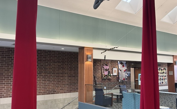 David Downing’s “Aerialist,” winner of the TSOS juror award hangs high above the Library lobby.