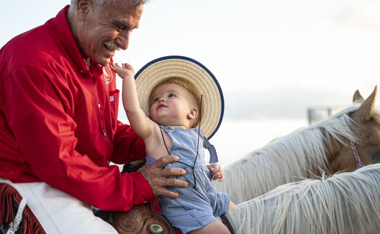 11-month-old Verlon Haire sits on a horse with his grandfather, Lee Brown, a member of the Williamson County Sheriff’s Posse Drill Team, just before granddad rode into the arena with team during the Williamson County Sheriff’s Posse Rodeo on Friday, June 27. (Photos by Andy Sharp)