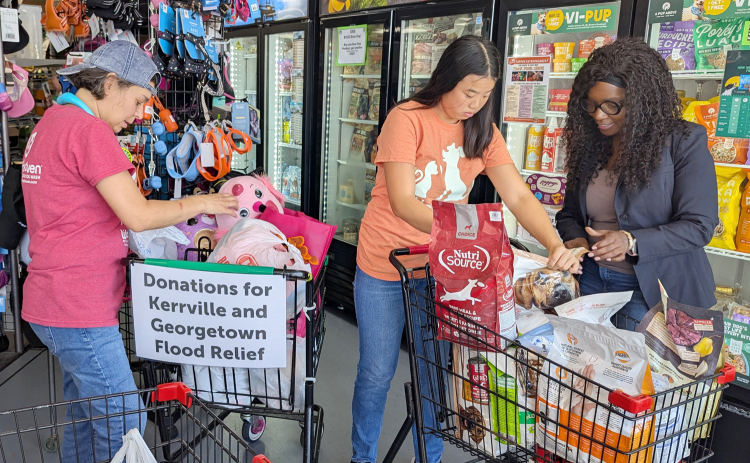 Kim Caito, General Manager, Summer Earn and Learn student Macy Sockwell and Wanda Young, Work Experience Trainer go through donations for Kerrville flood victims. (Photo Courtesy Jusak Yang Bernhard)