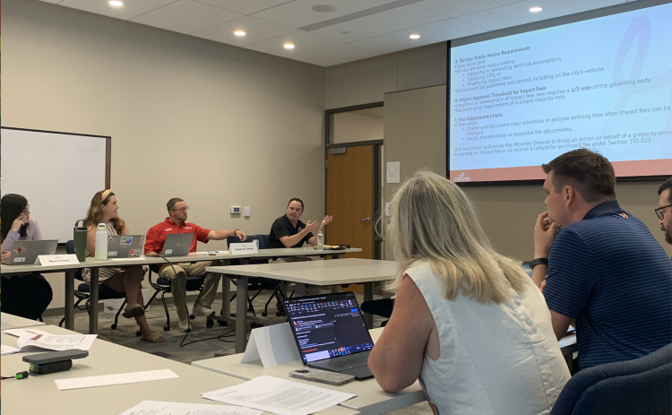 Georgetown Systems Engineering Director Wes Wright, middle, answers a question about impact fees during a special city council meeting on July 16. (Photo by Kaitlyn Wilkes)