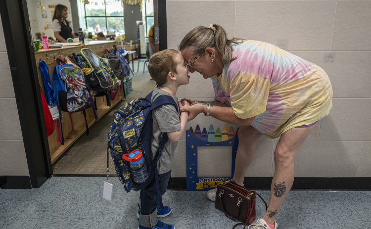 Pre-K student Alex Tafs, 4, spends quiet time with his grandmother Toni Powell before going into his classroom on the first day of school at Annie Purl Elementary School on Thursday, August 14, 2025.  Annie Purl has 650 students enrolled this academic year. Photo by Andy Sharp.