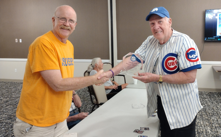 Talking Baseball’s programming director, Barry Harding (right), presents Bob Wilson with an award during the group’s August 13 meeting at The Delaney at Georgetown Village. Talking Baseball meets at The Delaney on the second and fourth Wednesday of each month. For several years, Mr. Wilson has kept his fellow participants supplied with baseball cards.
