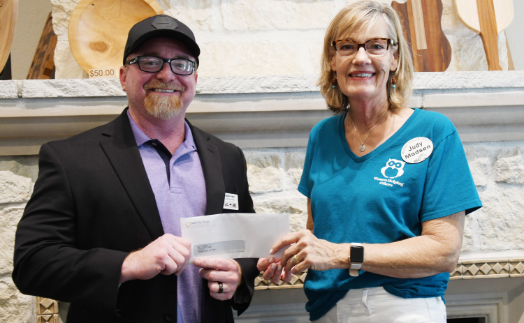 Jail To Job Program Director Eddie Franz, meets with Who Vice President Judy Madsen for a check presentation.