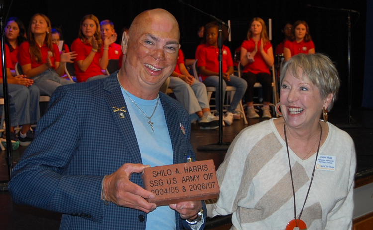 Keynote speaker Shilo Harris, right, receives a brick from Diane Klutz, the Veteran’s Memorial Advisory Group Chairwoman, that will be placed in Sun City’s Veteran’s Memorial Plaza. (Photos by Kaitlyn Wilkes)