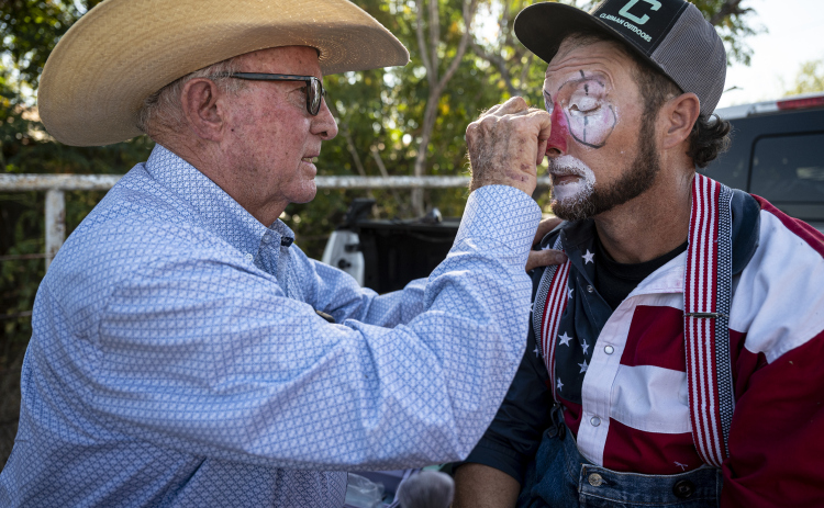 Larry Clayman,  left, helps apply clown makeup on his son, Matthew William Clayman at the 32nd Annual Clayman  Rodeo held at Windsong Farm on Saturday, October 4, 2025.  Larry Clayman, 85, a longtime rodeo clown and bullfighter is being inducted into the National Rodeo Hall of Fame on November 7-8.