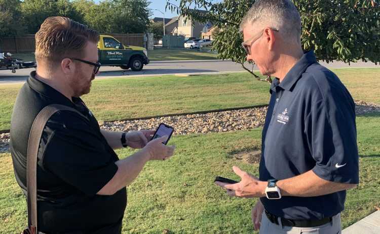 Customer Care Director Seth Gipson, left, and District 7 Councilman Ben Stewart put in a request on the askGTX app about an uneven sidewalk. (Photo by Kaitlyn Wilkes)
