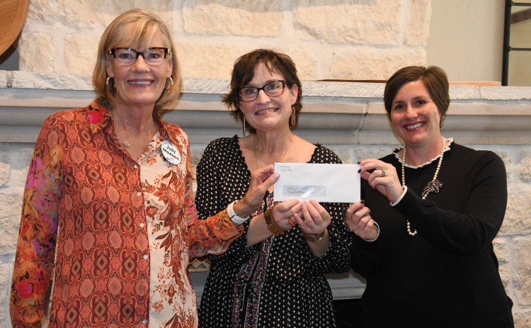 WHO VP Judy Madsen gives a donation to Carver Center Director Nita Riggins and STARRY Program Coordinator JJ Nisula.