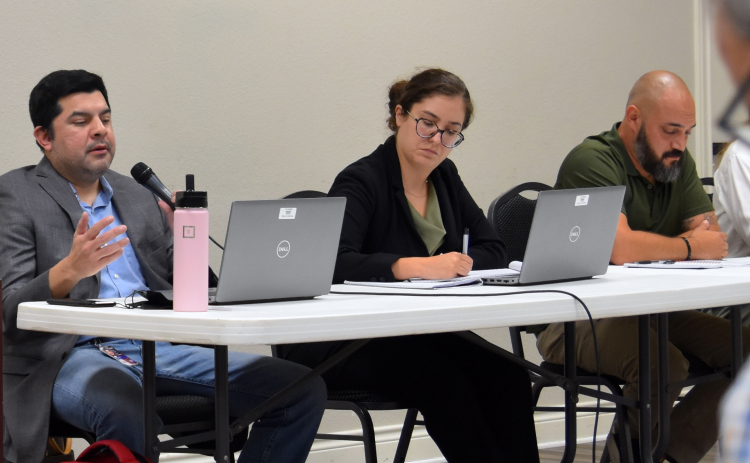 TCEQ employees, from left, Jose Alfonso Martinez, Maricela Zertuche and Alan Barraza were there to answer resident questions and explain the cleaning process for the wastewater. (Photo by Kaitlyn Wilkes)