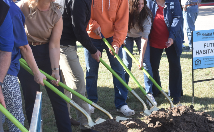 Habitat breaks ground on the Leander Street Cottages at 1839 Hart Street on November 22. From left are Amy Parham, Habitat Texas CEO; future homeowner Ashley Fordinal; Texas State Senator Charles Schwertner; Matthew and Belinda Schwertner, Senator Schwertner’s wife and son; and Shirley Harmes, Habitat volunteer.